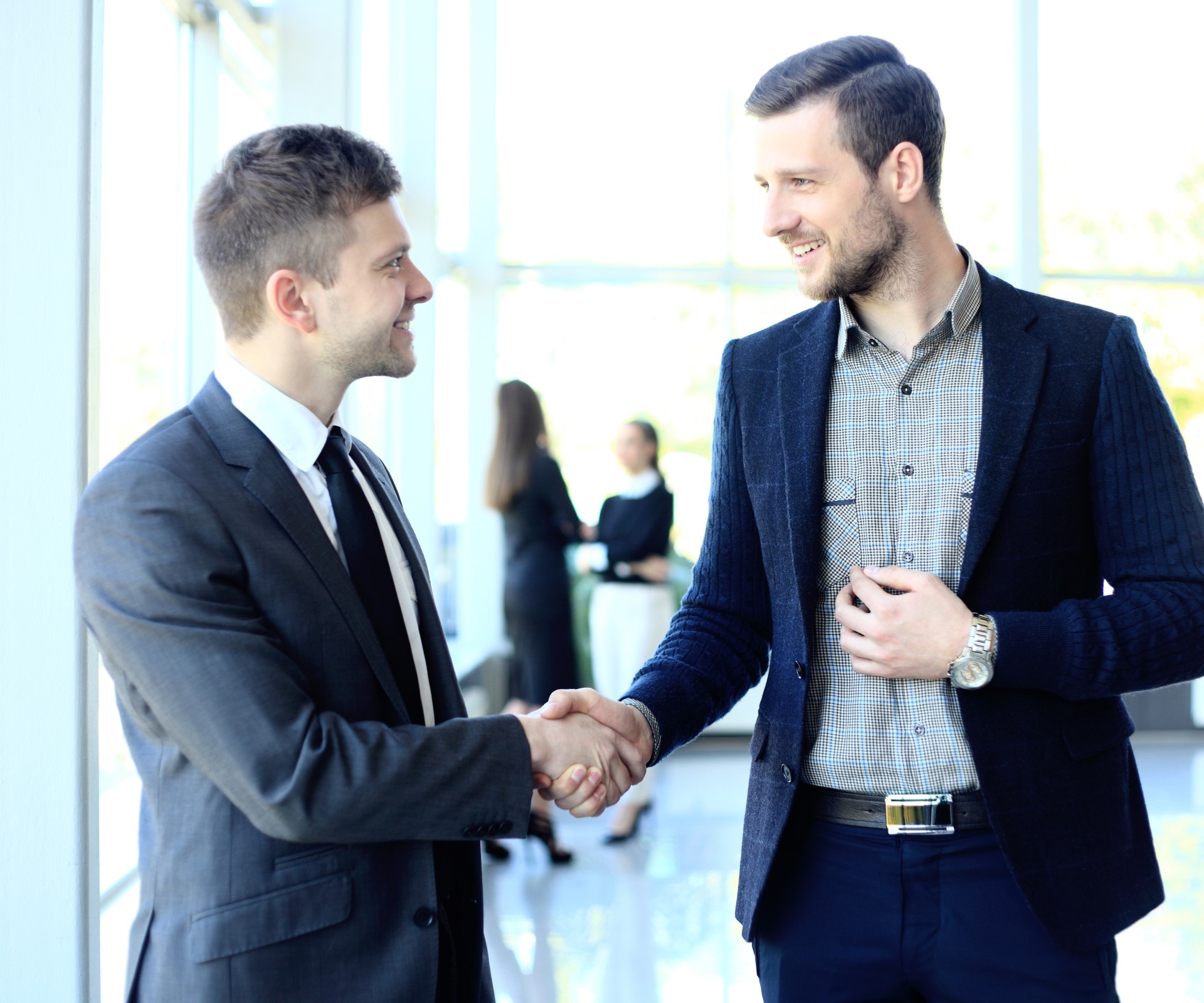 businesss and office concept - two businessmen shaking hands in